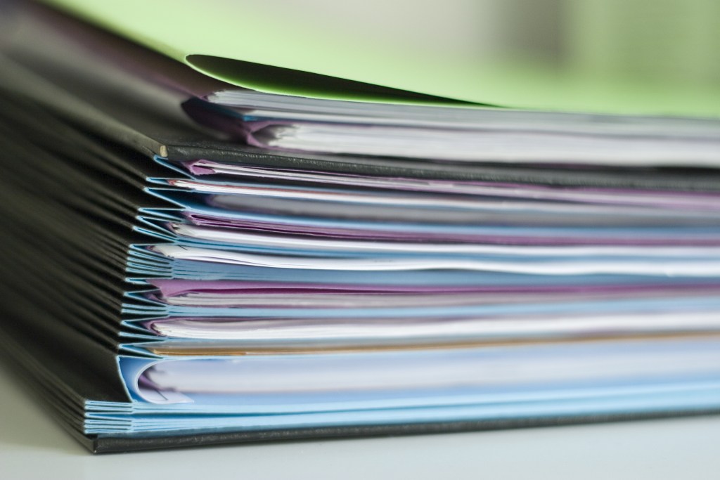 Dossiers Medtech dossiers in colorful file folders stacked neatly.