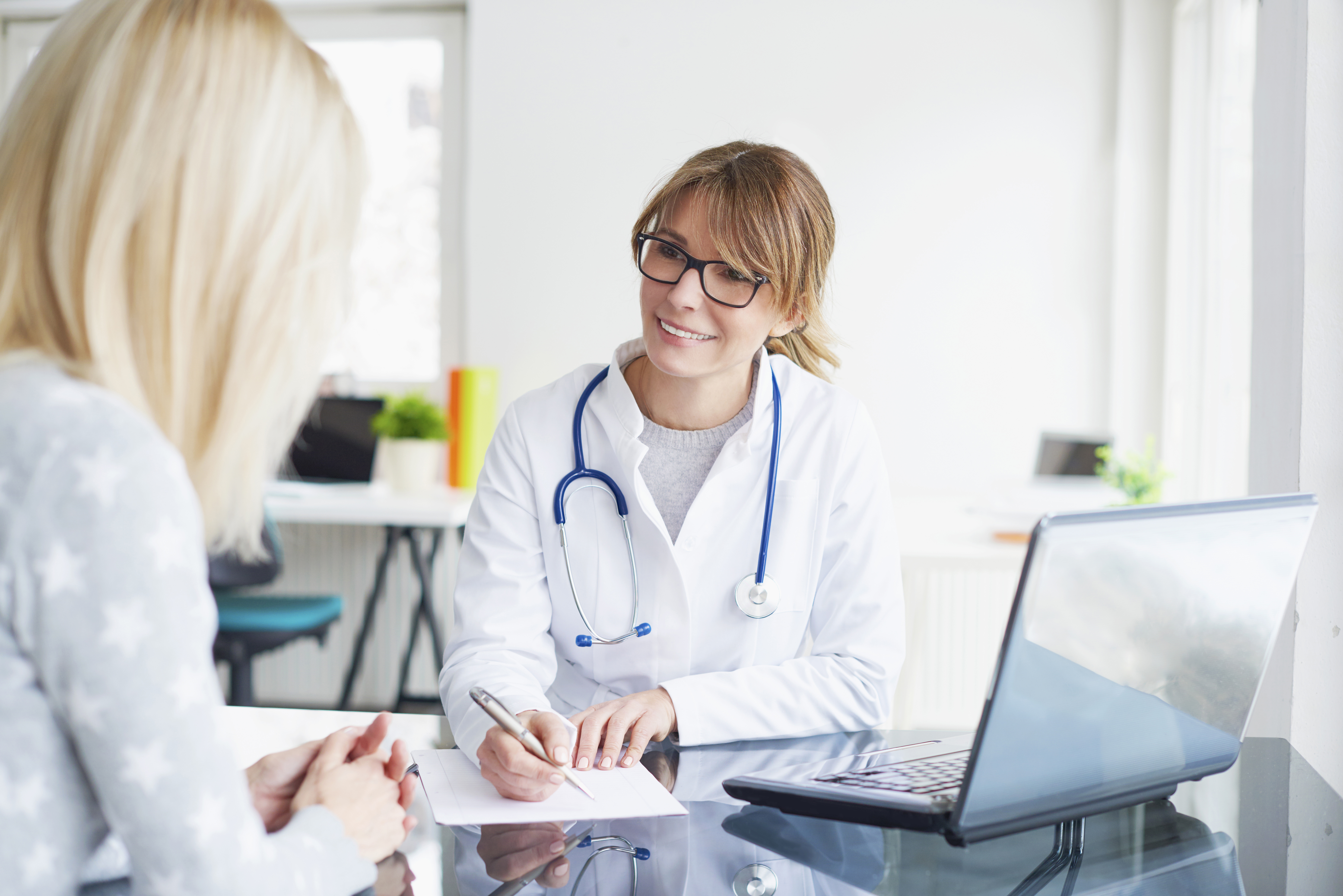 Female doctor discussing new medical technology with a market access expert.