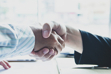 Stakeholder & Influencer Mapping Two men shaking hands.