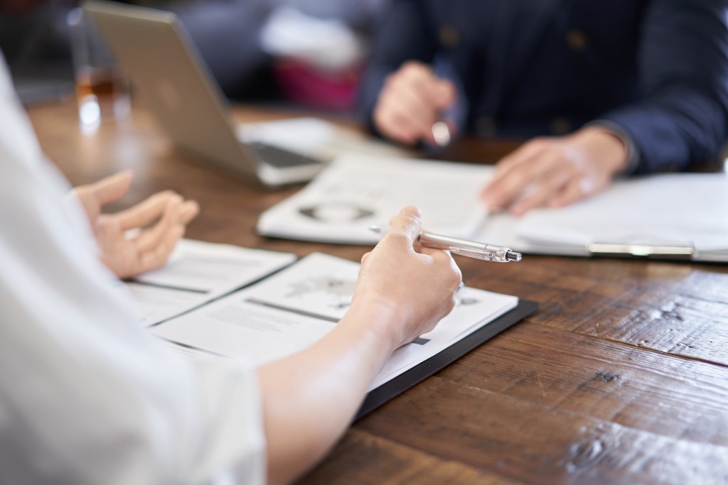 Qualitative Research Study Researchers looking over statistics from a qualitative research study